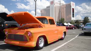Photo of orange classic pick-up.